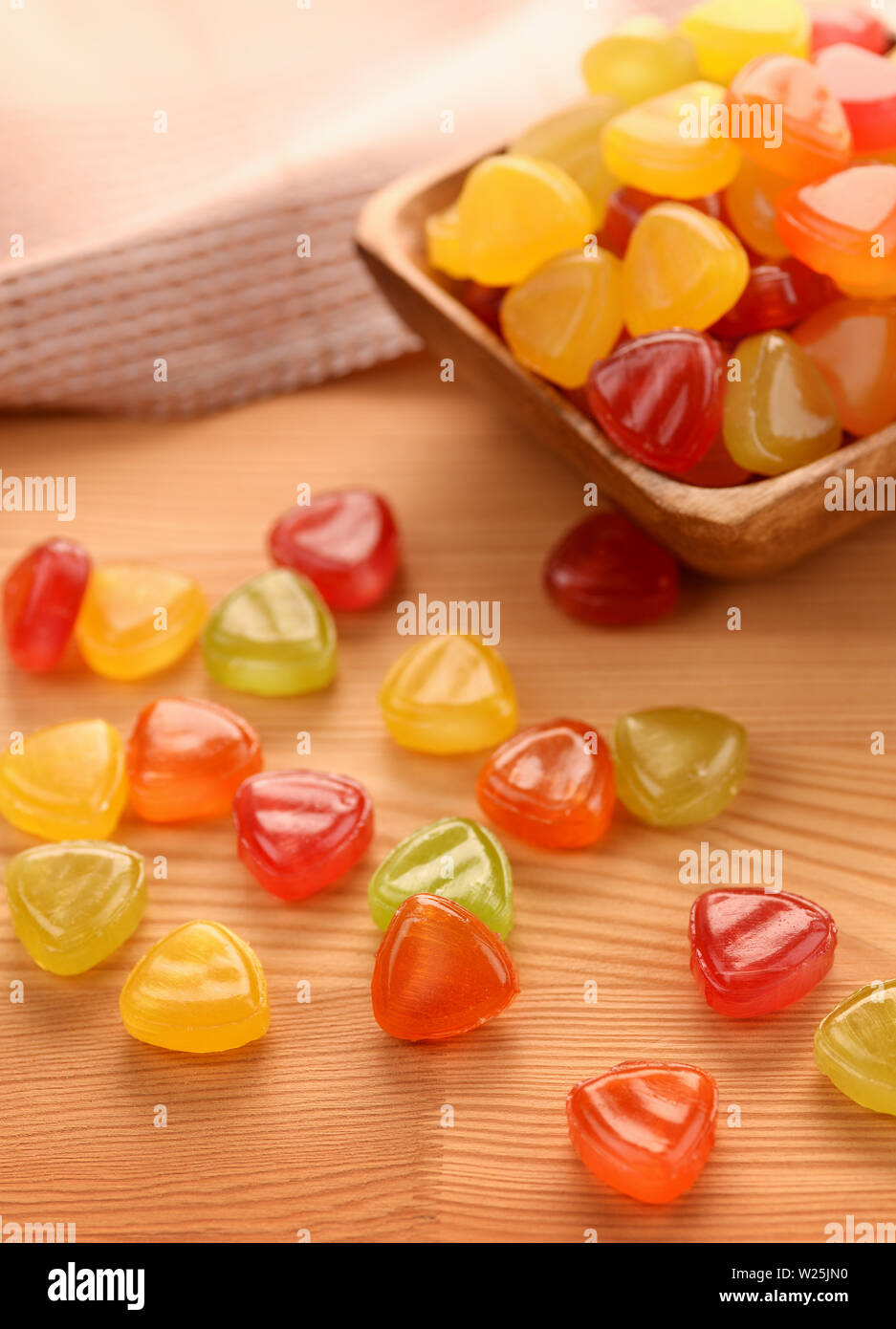 Colorful hard candies on unpainted wooden table Stock Photo