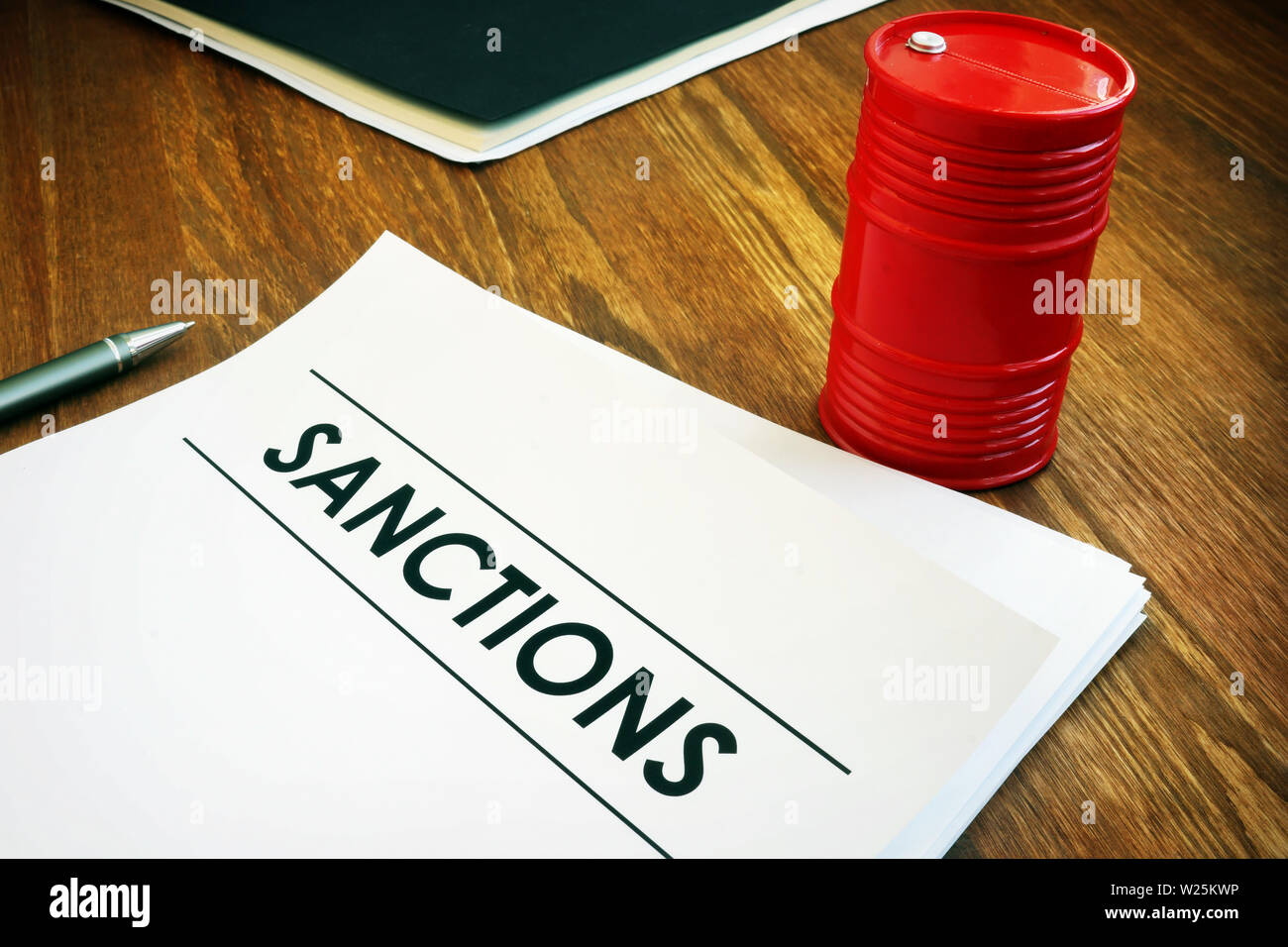 Sanctions list with model of oil barrel. Stock Photo