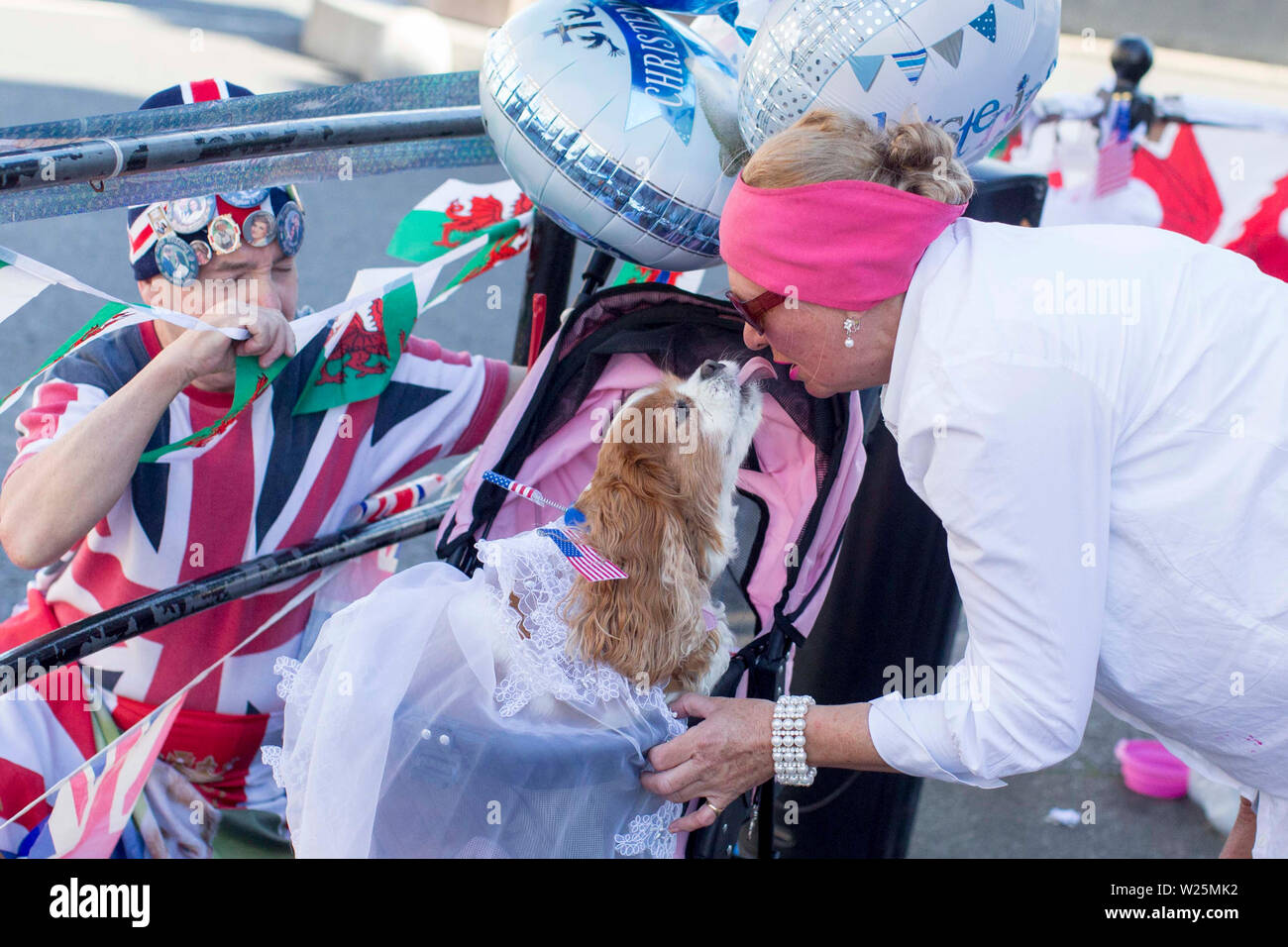 A moment between Camilla the dog and her owner Anne Daley as they wait to show their support in celebration of the royal christening of the Duke and Duchess of Sussex's son, Archie, in the castle's intimate private chapel. RESS ASSOCIATION Photo. Picture date: Saturday July 6, 2019. See PA story ROYAL Christening. Photo credit should read: Rick Findler/PA Wire Stock Photo