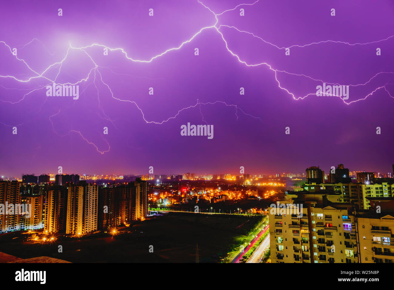 Multiple lighting bolts thunder during a storm with a dramatic blue sky
