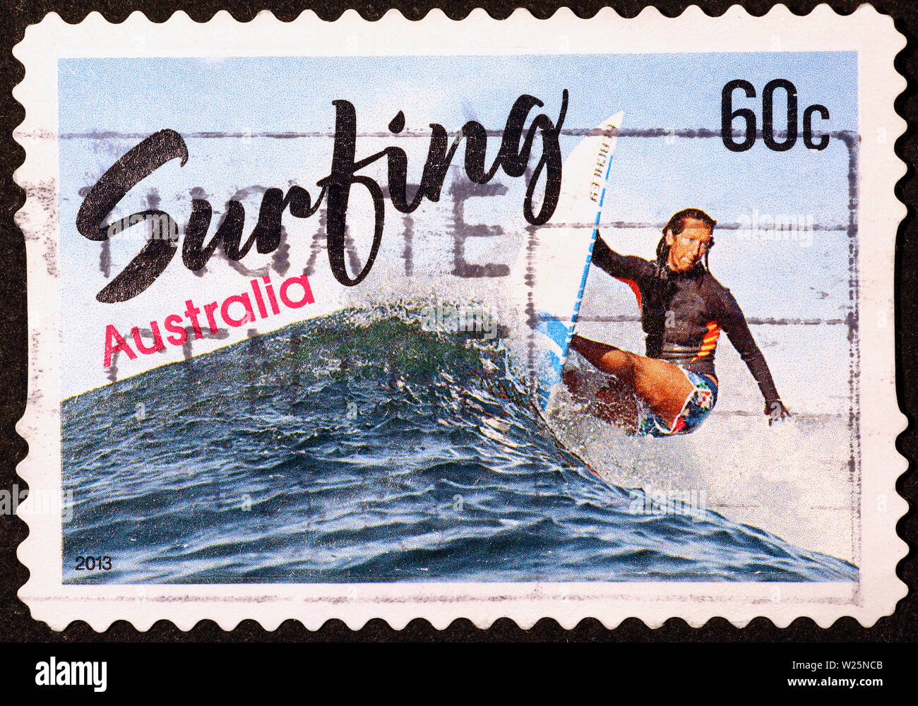 Woman surfing on australian postage stamp Stock Photo