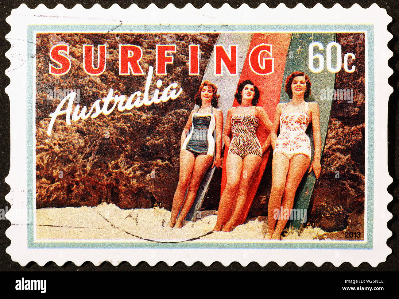 Women and surfboards on vintage australian postage stamp Stock Photo