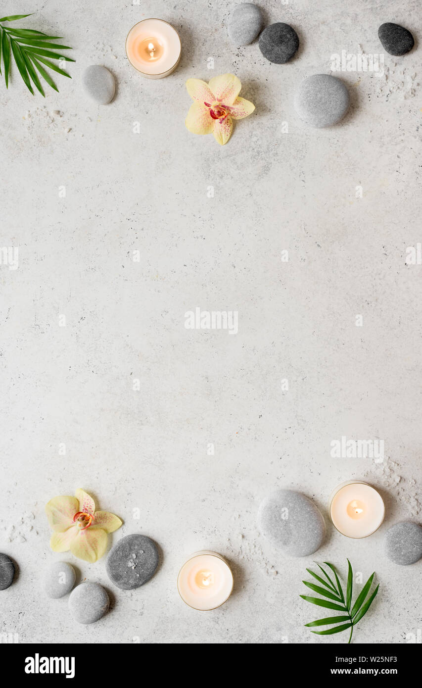 Spa concept on white stone background, palm leaves, flowers, candles ...