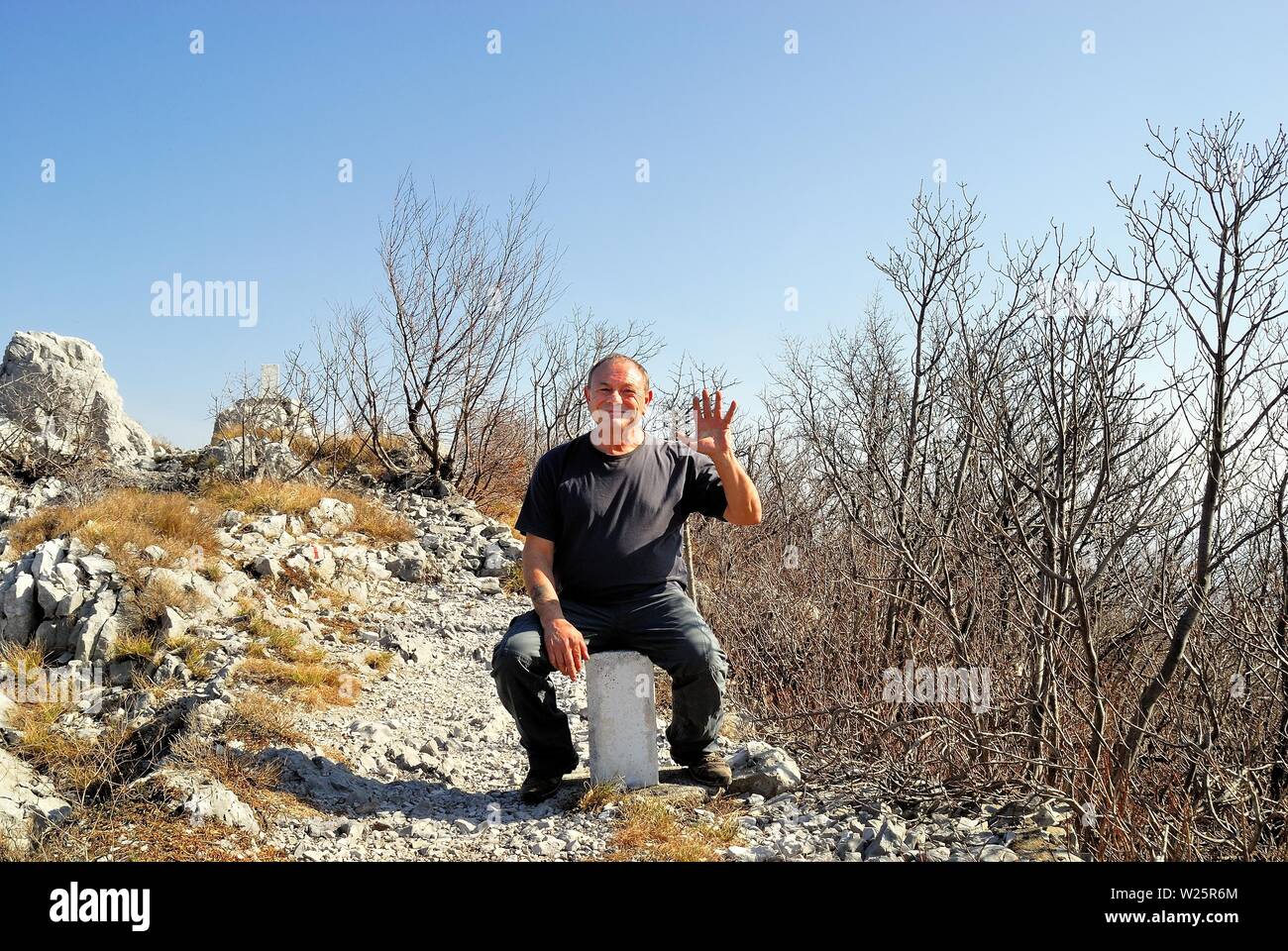 The Italian-Slovenian border was the scene of bloody battles during the WWI. It was part of the Iron Curtain during the Cold War years. On that border the circulation has been free for 20 years. Now the Italian interior minister Matteo Salvini and the President of the Friuli Venezia Giulia Region Massimiliano Fedriga want to build a wall on that border to counter the arrival of migrants on the Balkan route. Trieste Karst, the Italian-Slovenian border where Salvini wants to build the wall. Alamy's photographer Ferdinando Piezzi poses for a photo on a border pillar. Stock Photo