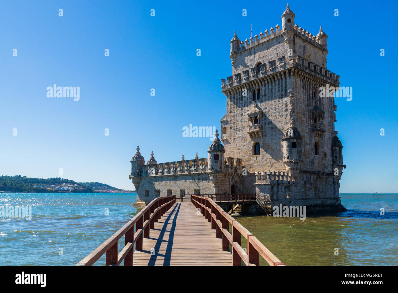 Scenic Belem Tower and wooden bridge miroring with low tides on Tagus ...