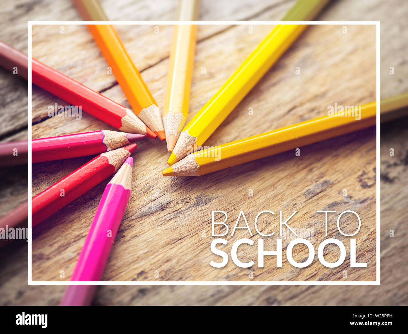colorful color pencils on old wooden table with text back to school Stock Photo