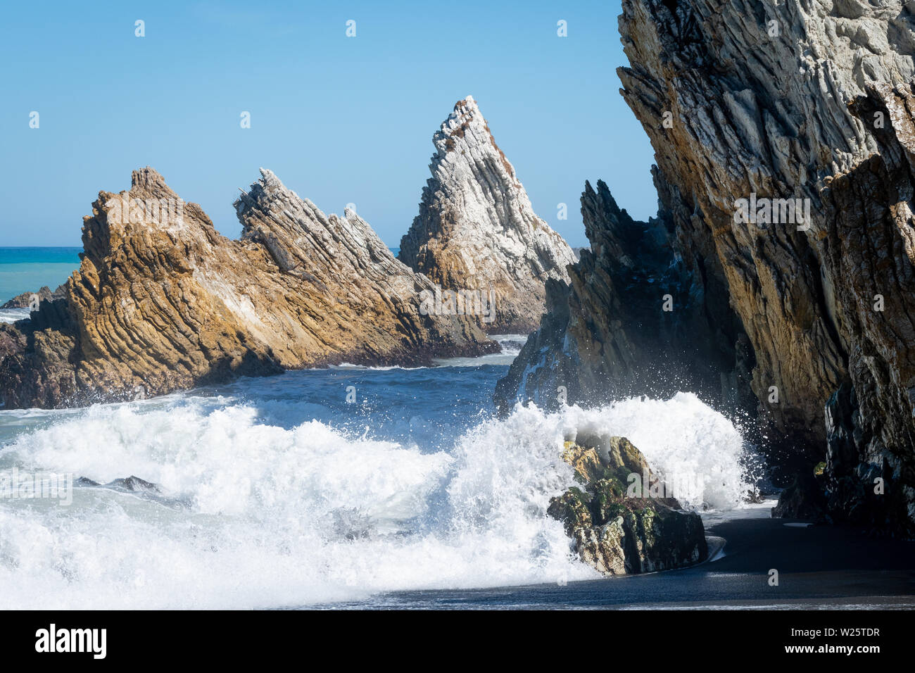 Waves breaking on rocks, White Rock, Wairarapa, North Island, New Zealand Stock Photo