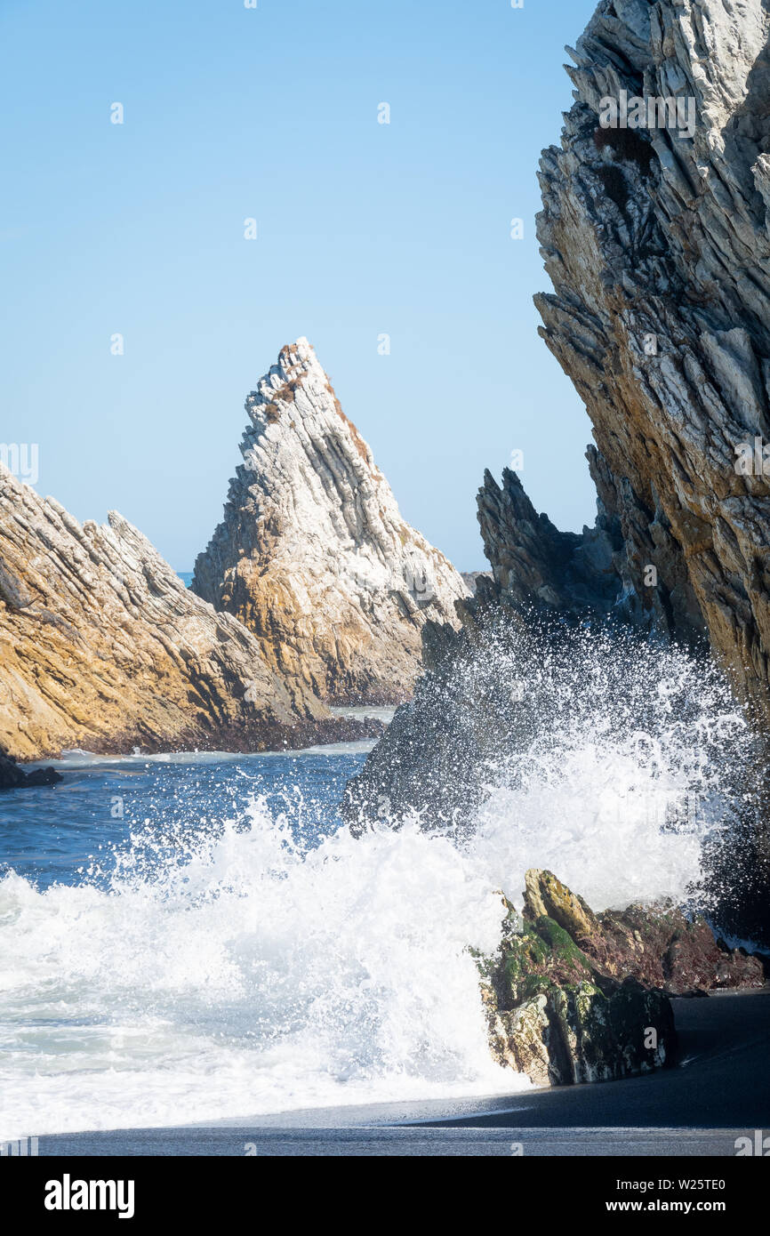 Waves breaking on rocks, White Rock, Wairarapa, North Island, New Zealand Stock Photo