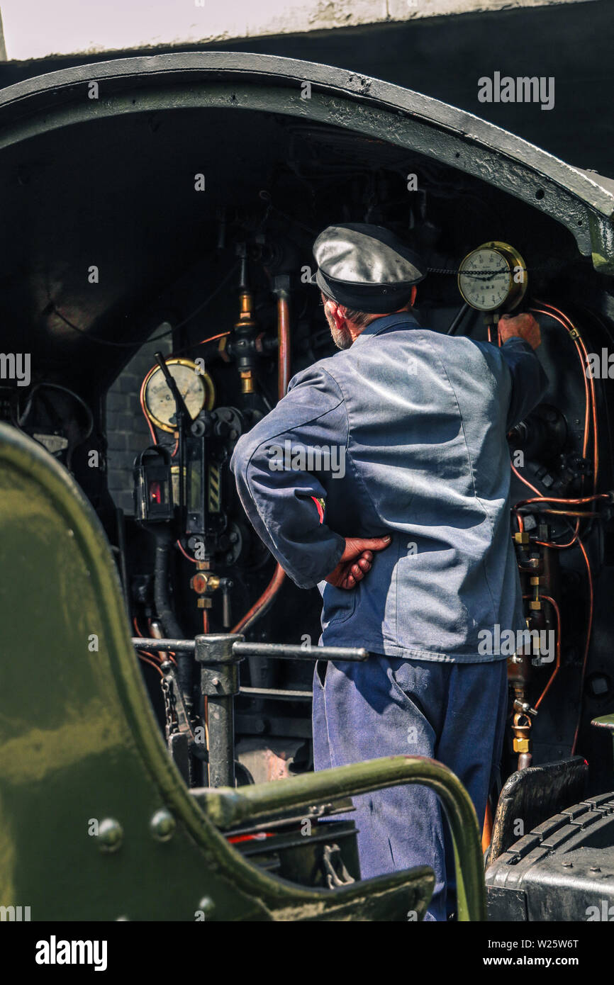 Driver on a heritage railway vintage steam train Stock Photo