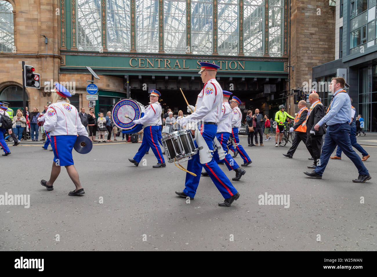 The 2019 annual Orange Walk in Glasgow attracts thousands of onlookers and participants. The parade this year is taking a modified route after an incident in 2018 in which a catholic priest was spat on. Stock Photo