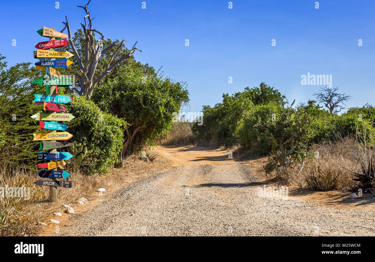 Funny different world directions signpost with distance to many different countries Stock Photo