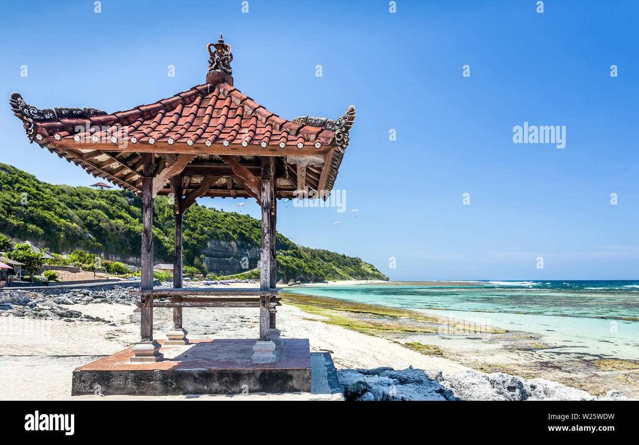 Traditional hut on balinese beach in Indonesia Stock Photo