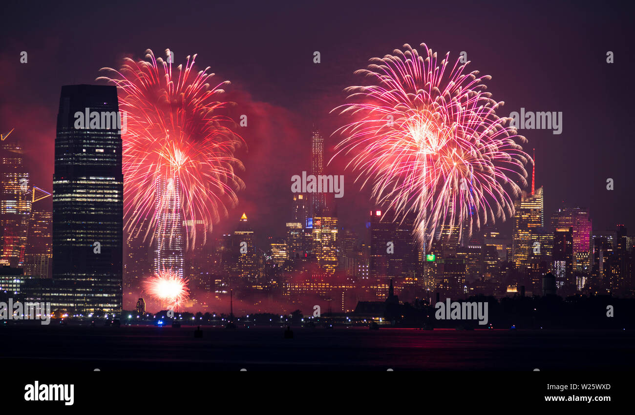 Fireworks are being set off from barges on the river between Jersey