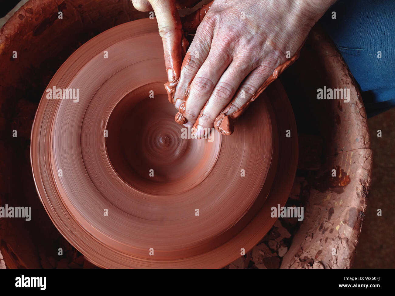 Professional potter making bowl in pottery studio Stock Photo