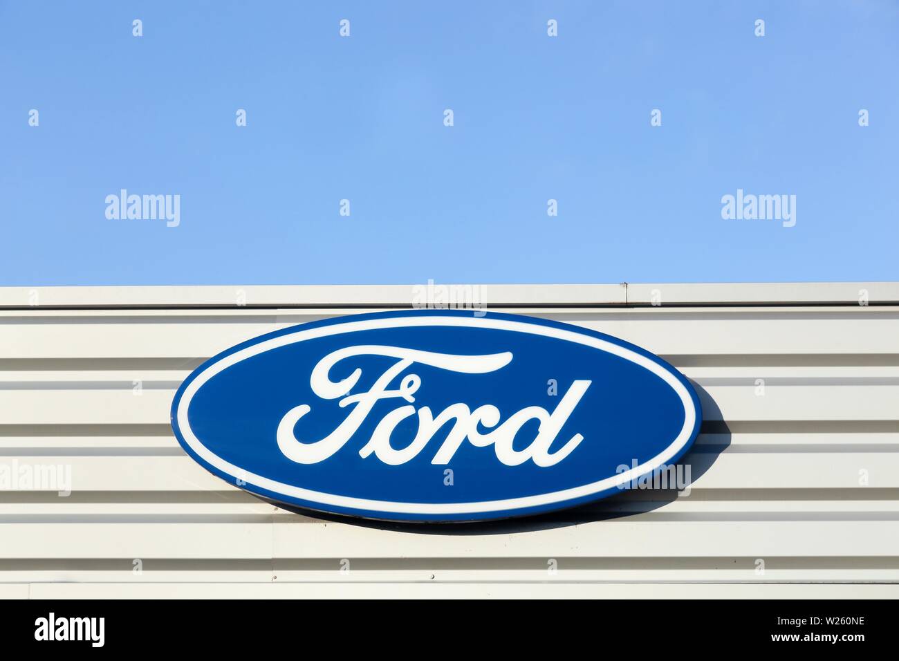 Belleville, France - September 20, 2015: Ford logo on a facade of a dealer. Ford is an American multinational automaker Stock Photo