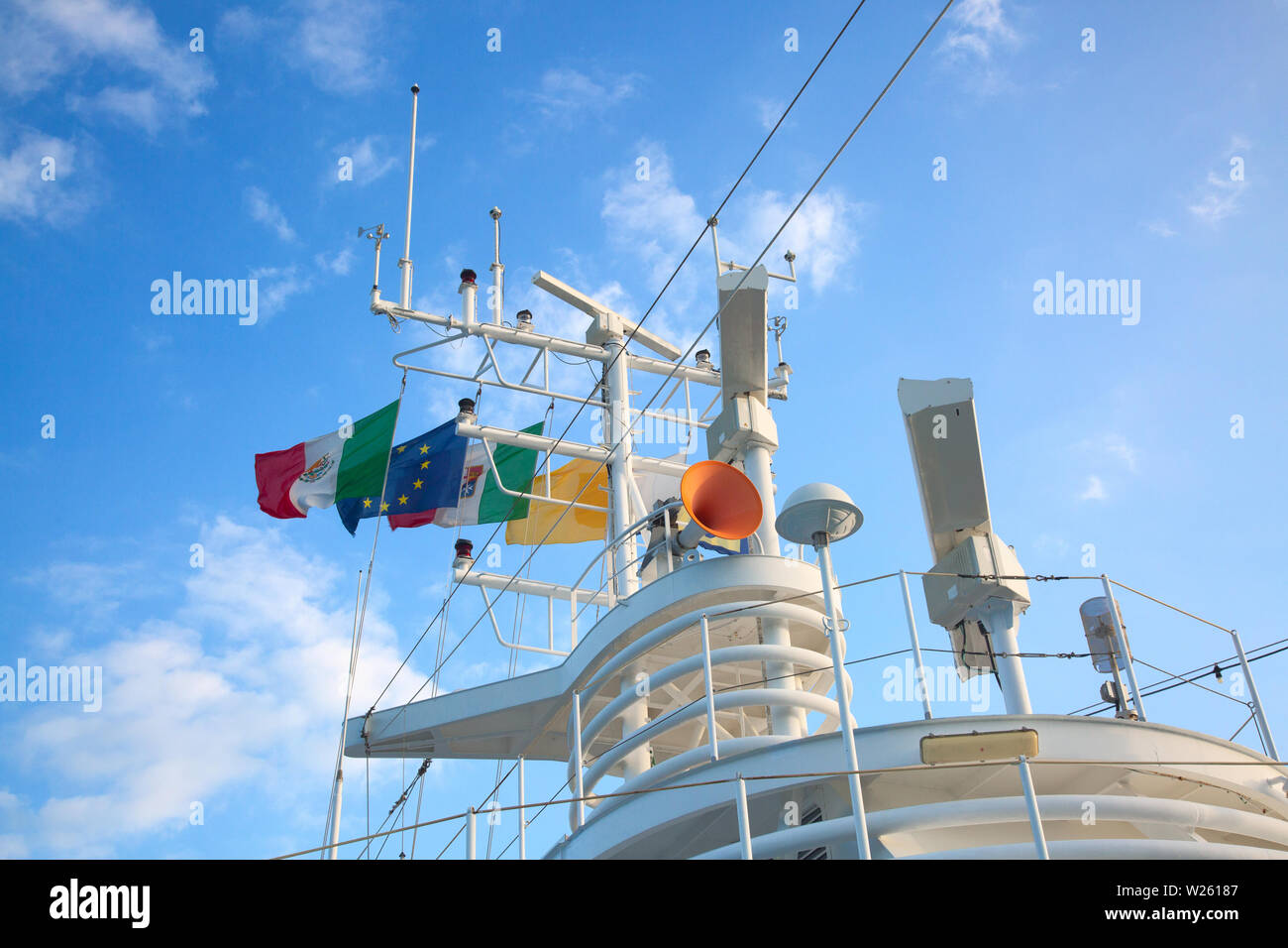Navigation equipment and masts of cruise ship decorated with flags ...