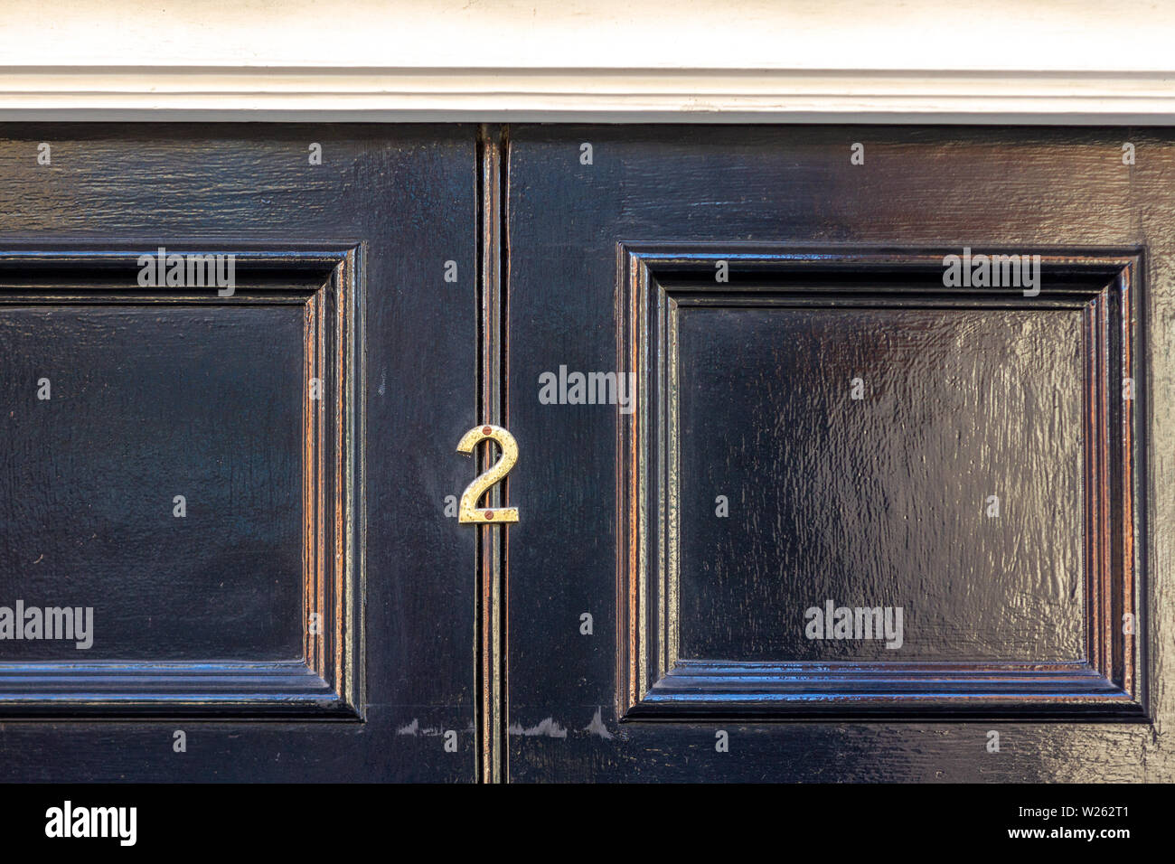 House number 2 with the two in metal digits on a wooden front door and ...