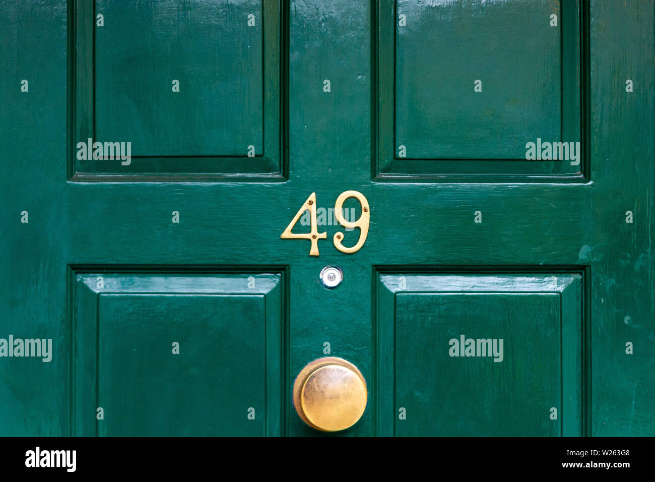 House number 49 with the forty-nine in metal digits on a wooden front door Stock Photo