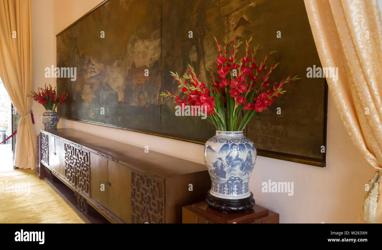 Detail of Painting, Red Flowers antique vase and furniture from Presidential Dining Room in Reunification Palace Ho Chi Minh City Vietnam Stock Photo