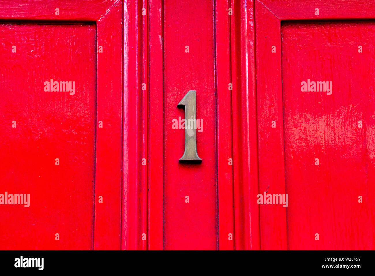 House number one with the 1 in metal digits on a wooden front door