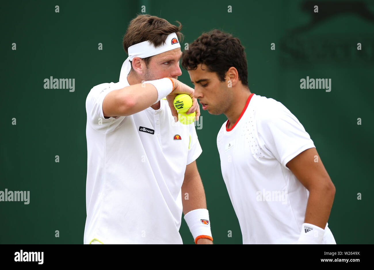 Cameron Norrie (left) and Jaume Munar during the gentlemen's doubles on day six of the Wimbledon Championships at the All England Lawn Tennis and Croquet Club, Wimbledon. Stock Photo