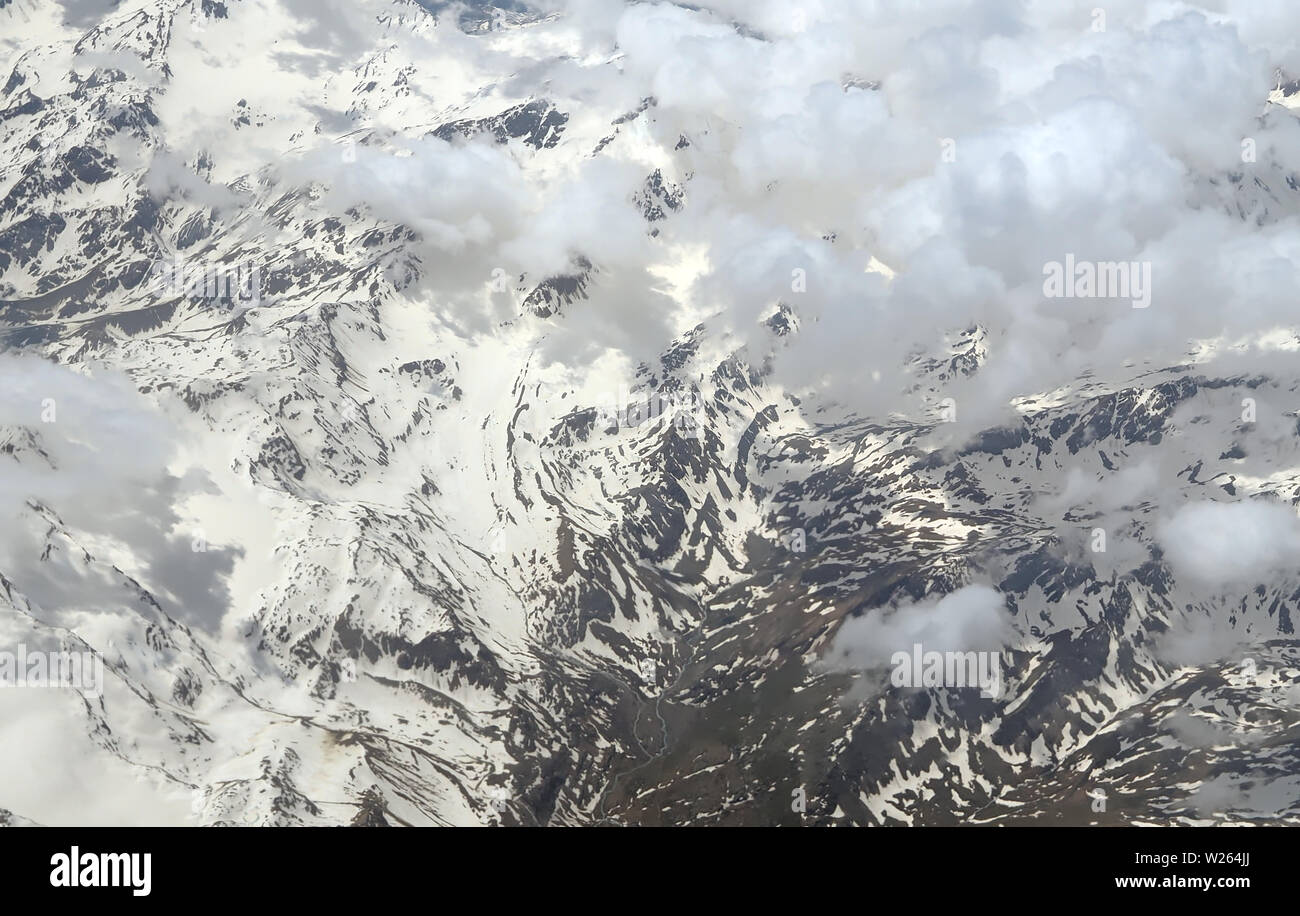 Aerial view of clouds over the Alps or Alp mountains between Swiss and ...