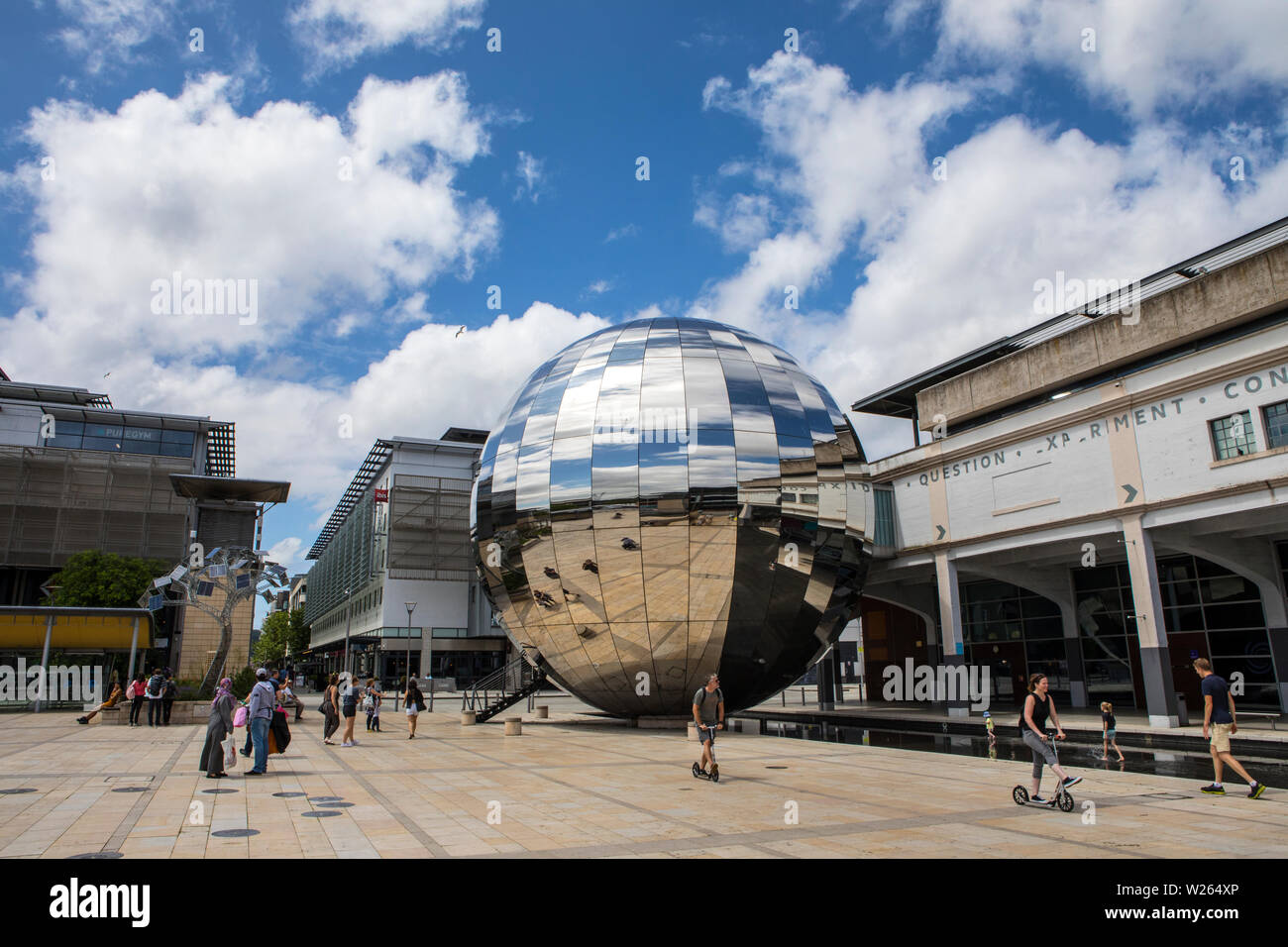 Bristol, UK - June 30th 2019: A view of Millennium Square in the city of Bristol in the UK.  The large reflective silver sphere is home to a Planetari Stock Photo