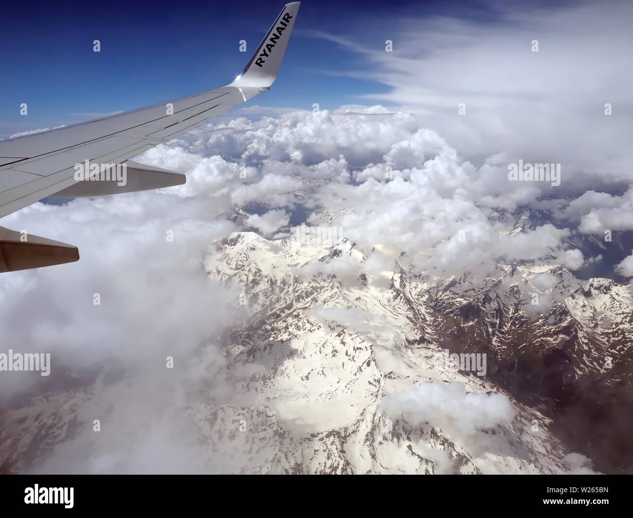 Aerial view of clouds over the Alps or Alp mountains between Swiss and ...