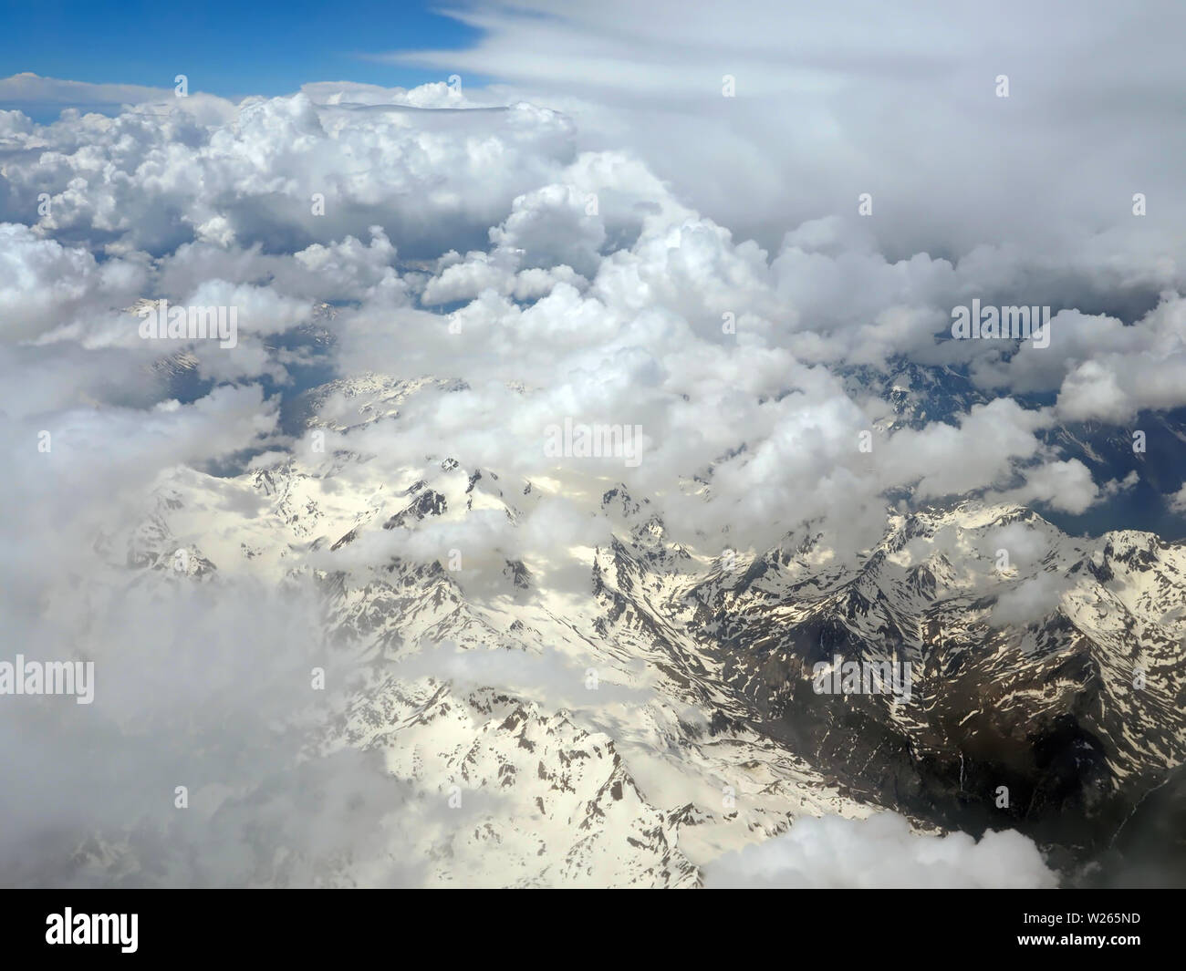 Aerial view of clouds over the Alps or Alp mountains between Swiss and ...
