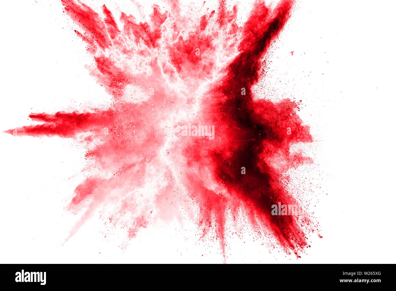 Abstract red dust splattered on white background. Red powder explosion.Freeze motion of red particles splash. Stock Photo