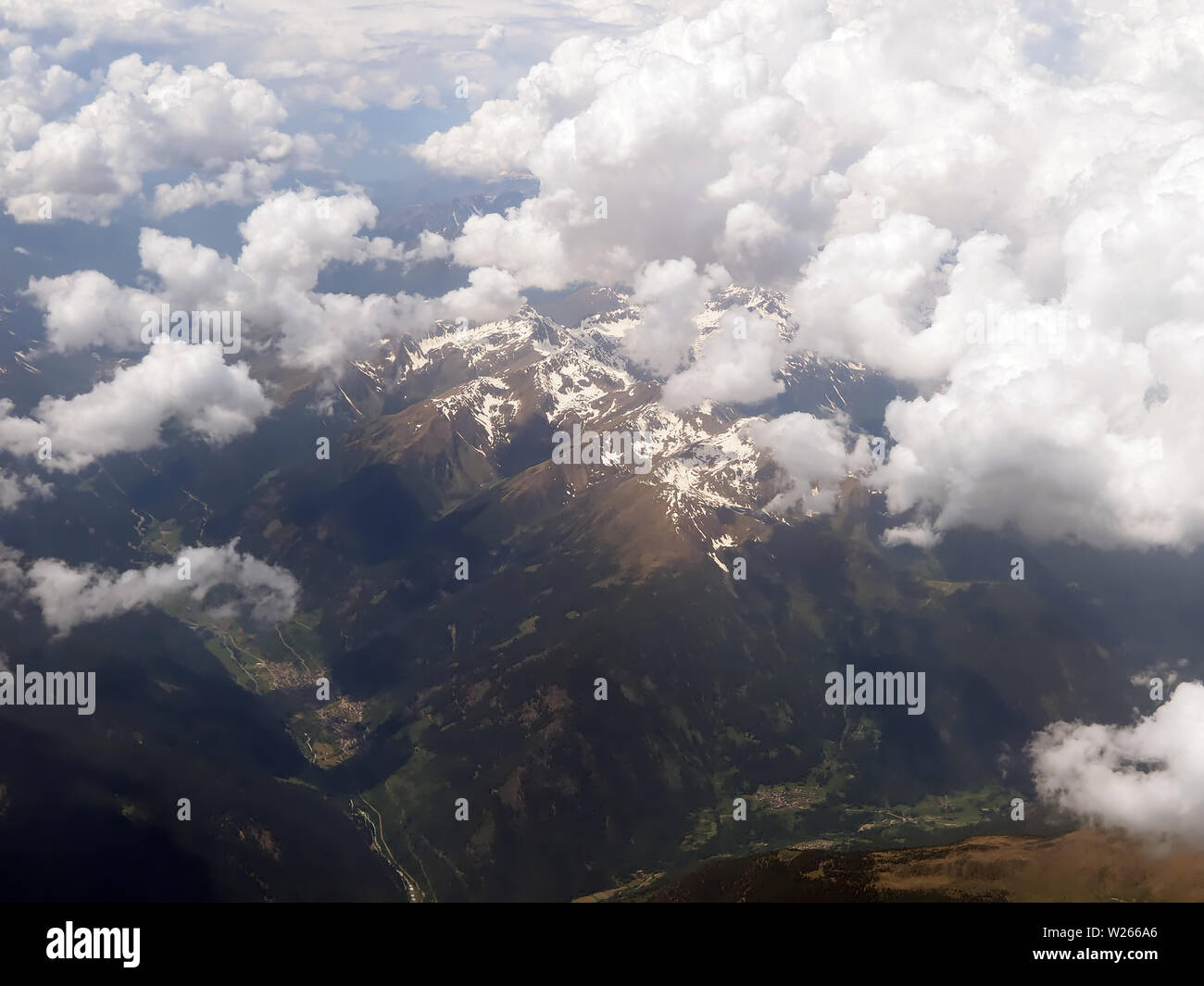 Aerial view of clouds over the Alps or Alp mountains between Swiss and ...