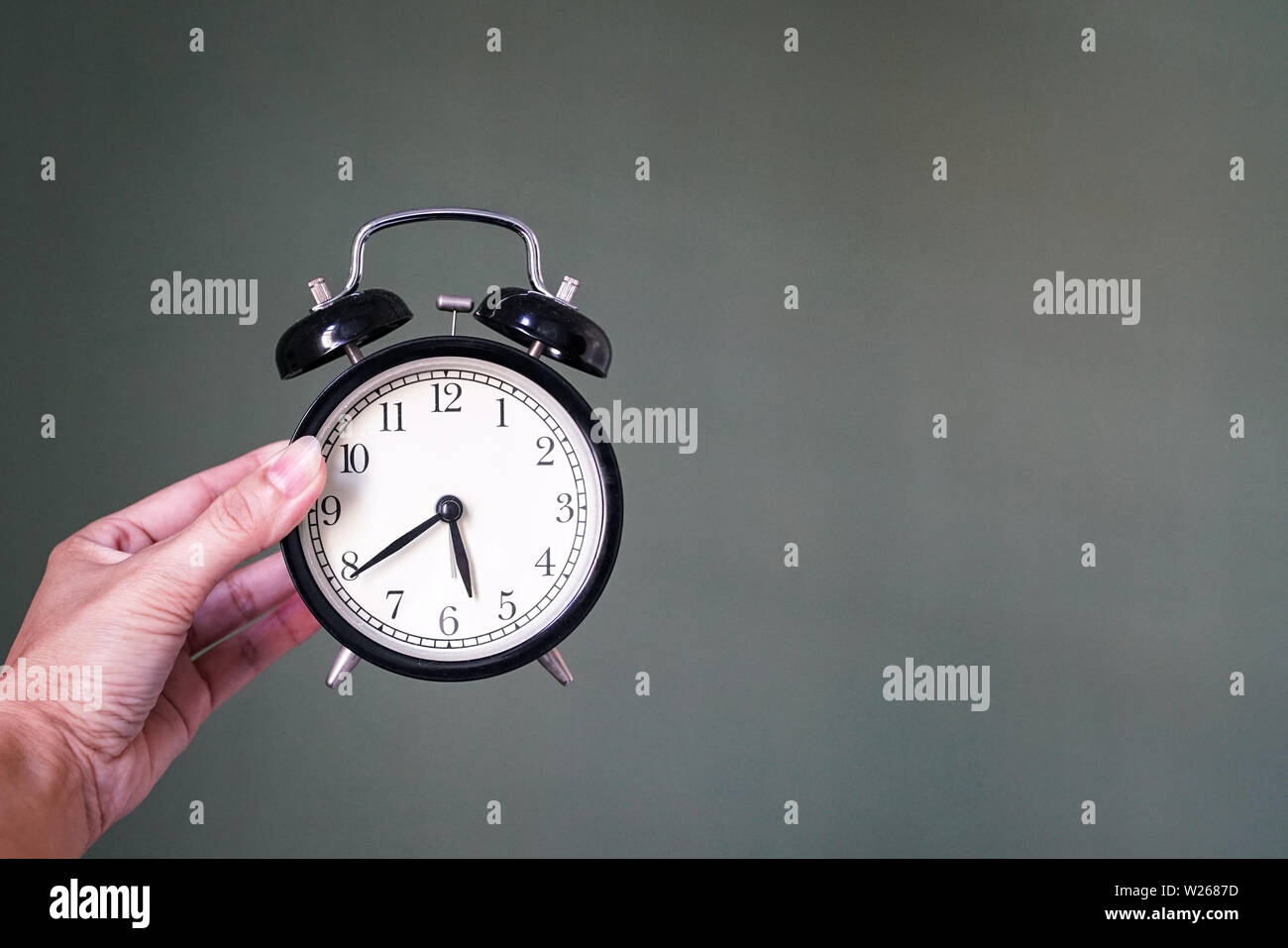 Hand holding an alarm clock, wake up or time concept Stock Photo Alamy