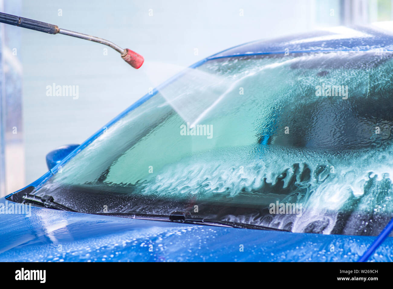 Cleaning Car Using High Pressure Water.Manual car wash with pressurized water in car wash
