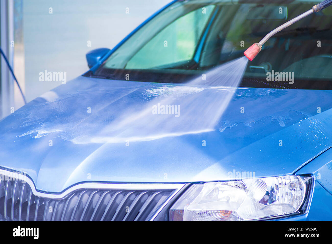 Cleaning Car Using High Pressure Water.Manual car wash with pressurized water in car wash