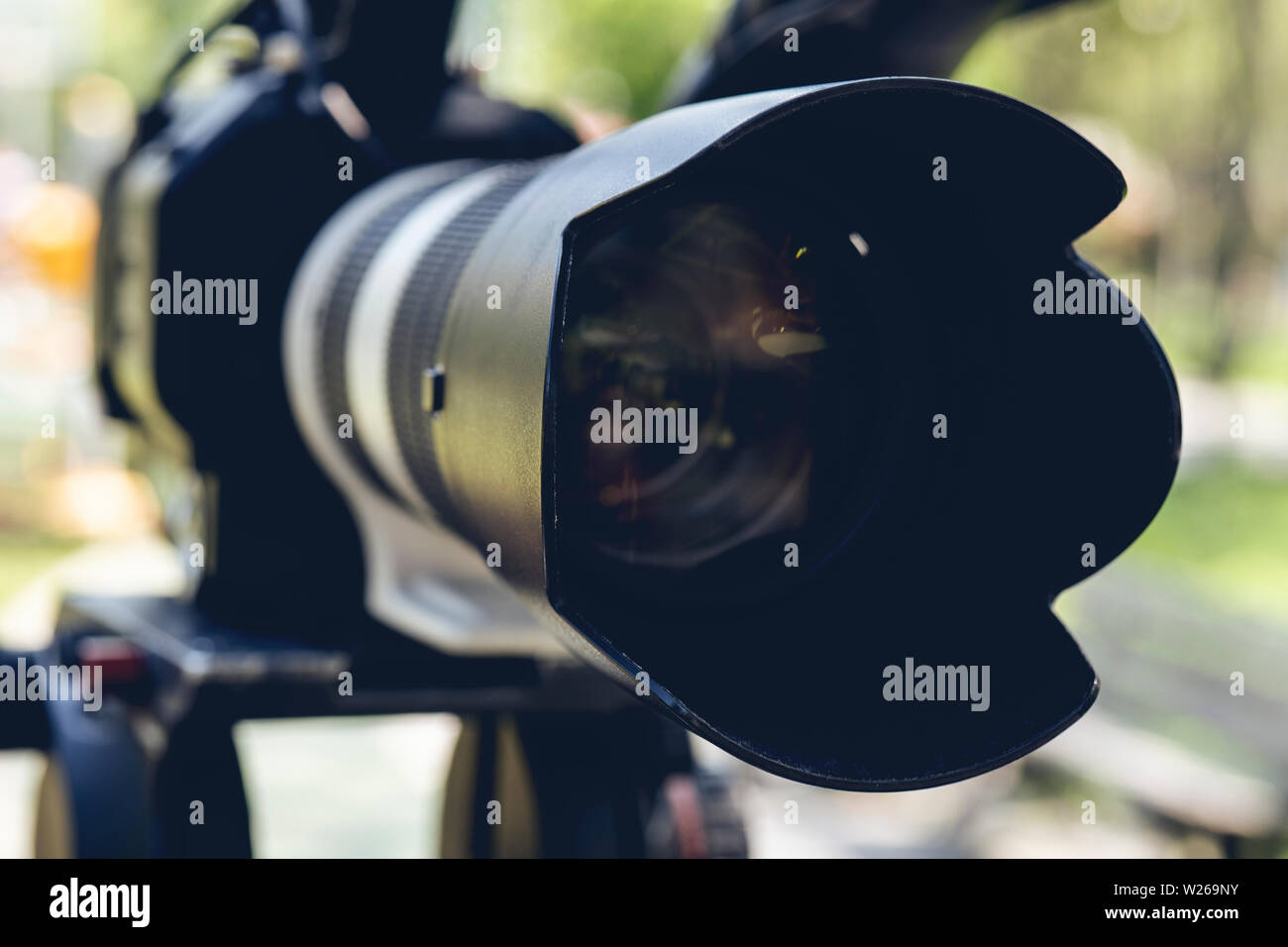 Super close up of Professional Video Camera. The Focus is on the lens and the front part Stock Photo