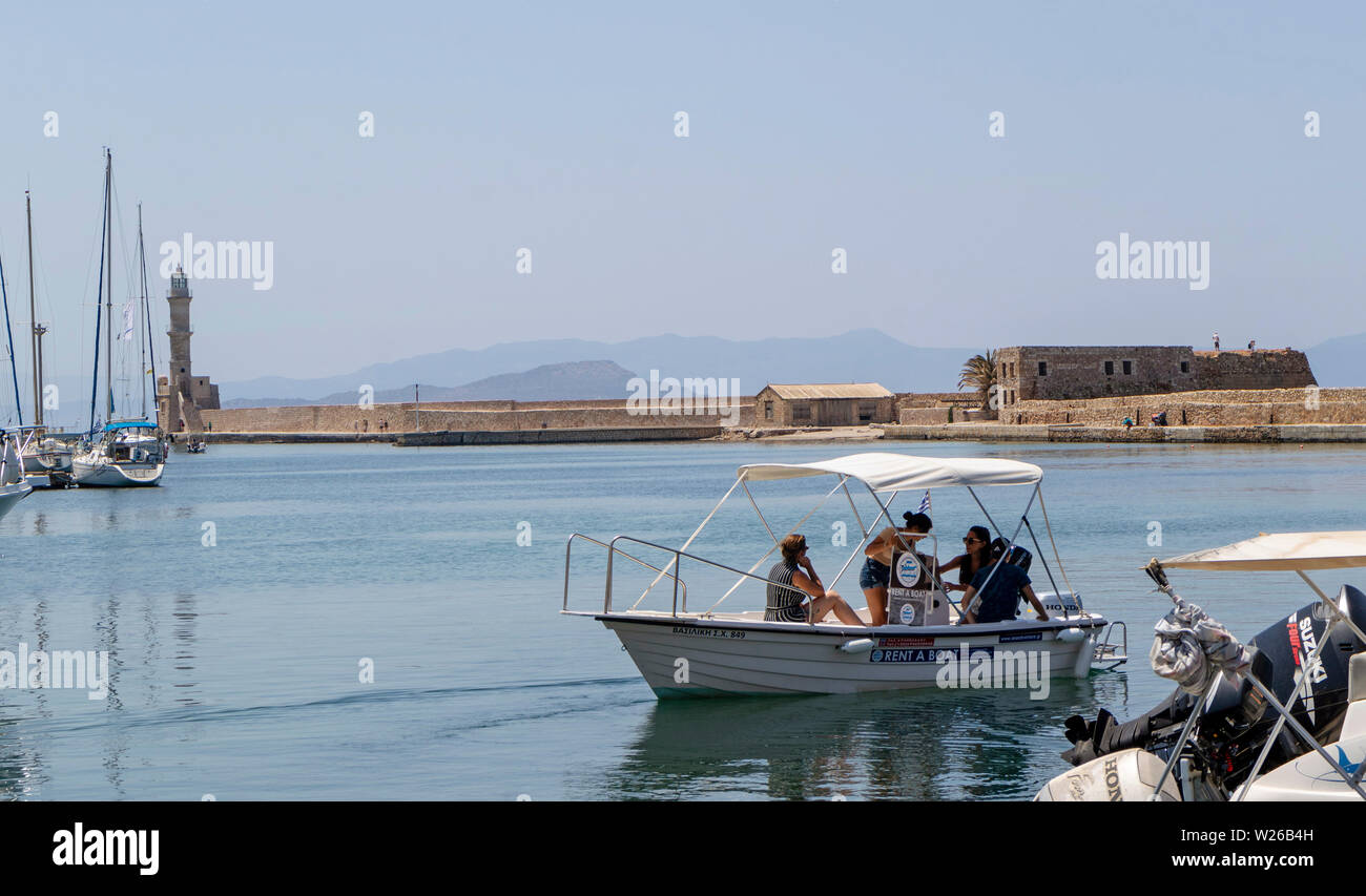 Chania, Crete, Greece. June 2019. The Old Venetian Harbour in Chania, people learning to control their hire boat Stock Photo