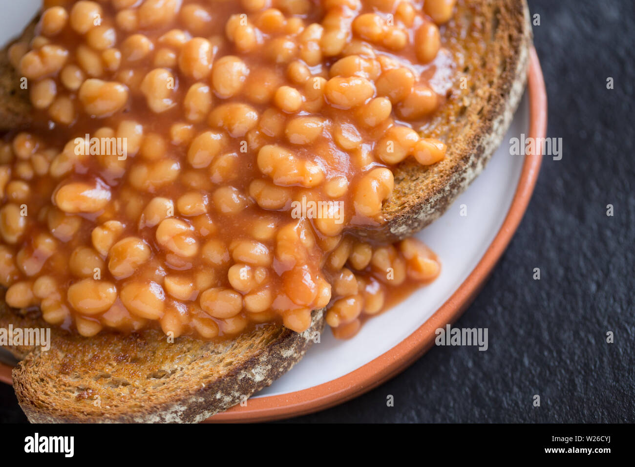 A portion of baked beans on toast served for breakfast. Dorset England UK GB Stock Photo