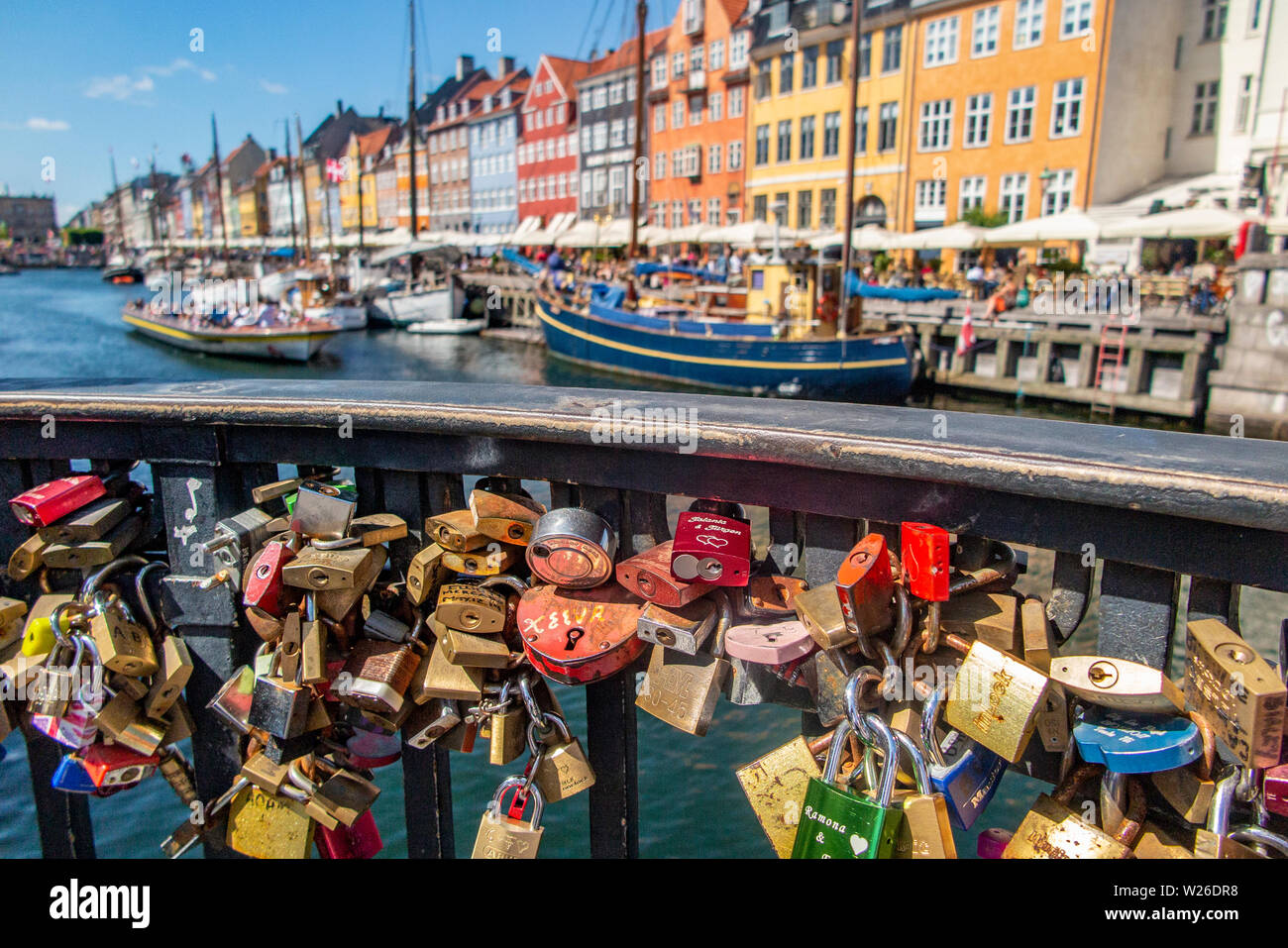 Padlocks adorn Nyhavensbroen bridge in Copenhagen's Nyhavn, a popular tourist attraction Stock Photo