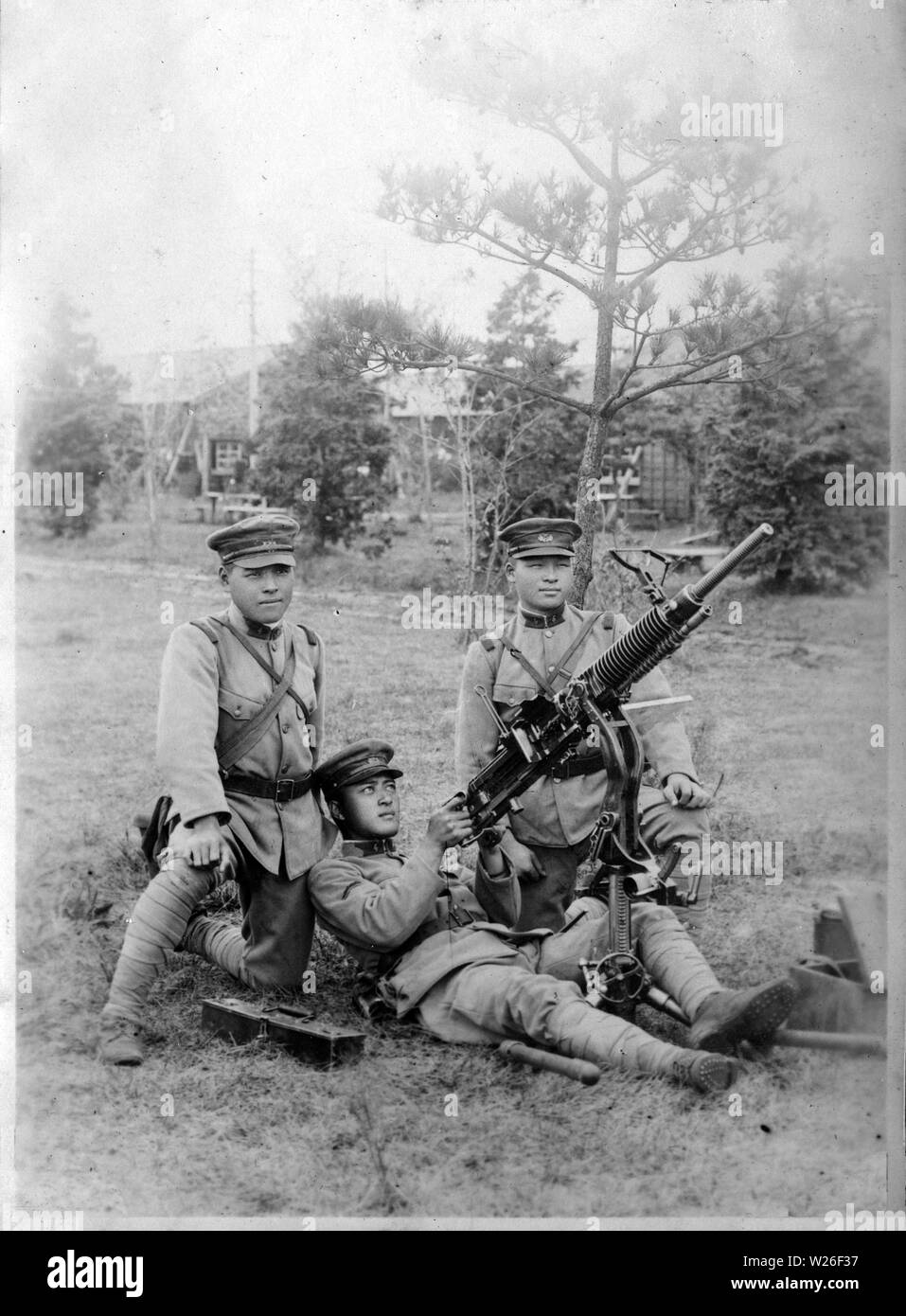 [ 1920s Japan - Japanese Soldiers with Machine Gun ] —   Three soldiers with what appears to be a Type 3 Heavy Machine Gun (Sannen-shiki Juu-kikanjuu).  From a private photo album of a member of the Japanese Imperial Guard (Konoe Shidan) who served between 1928 (Showa 3) and 1930 (Showa 5).  20th century vintage gelatin silver print. Stock Photo
