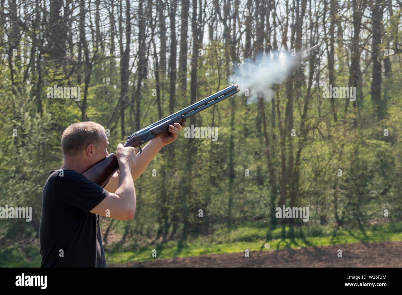 Man shooting at a clay pigeon shoot Stock Photo