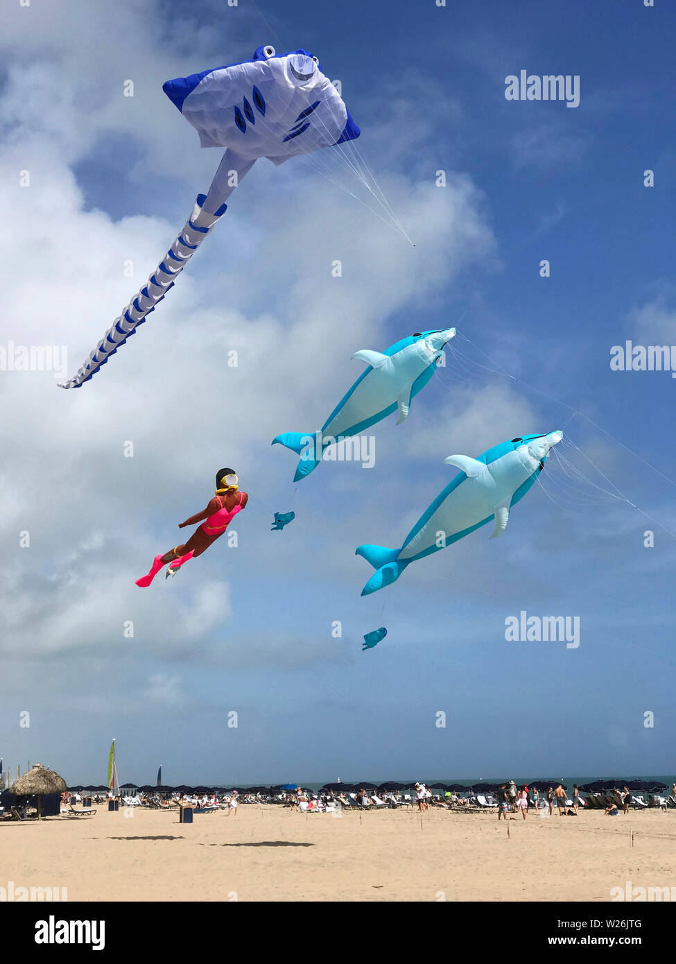 Kites in the shape of dolphins, a sting ray and a female scuba diver
