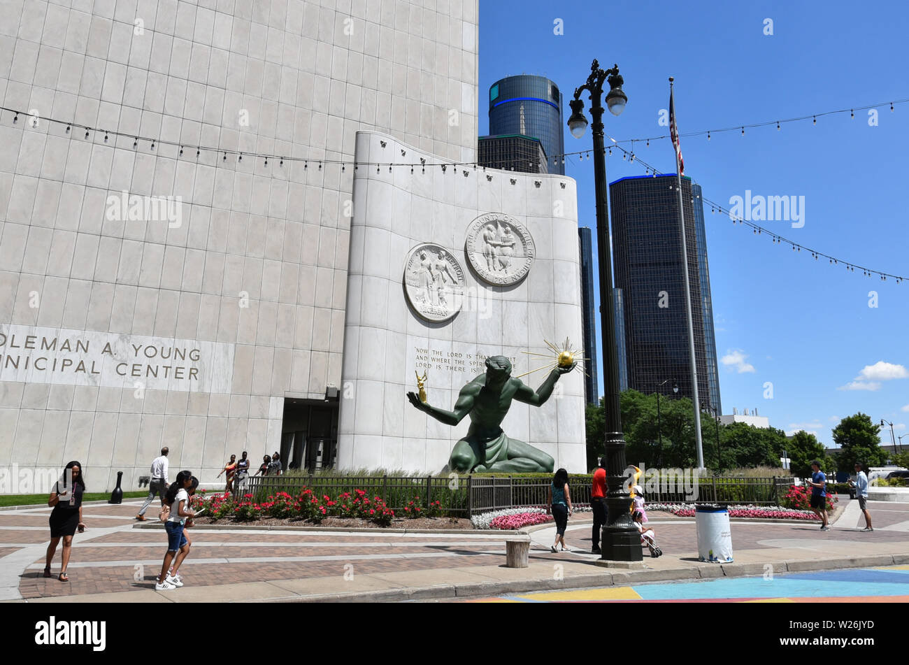DETROIT, MI / USA - JUNE 30, 2019:  Visitors walk past the Spirit of Detroit sculpture, with the Renaissance Center in the background. Stock Photo