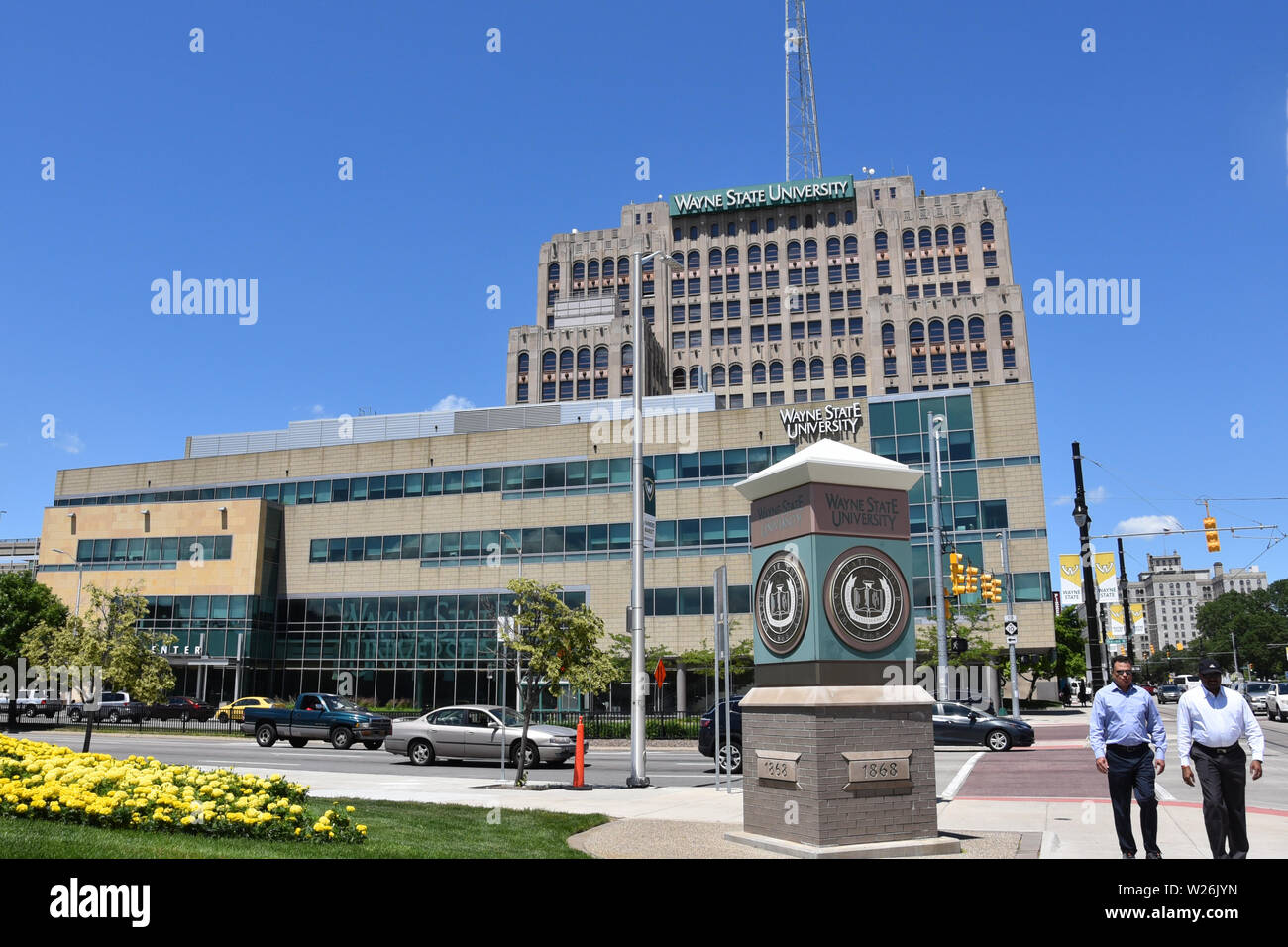 DETROIT, MI / USA - JUNE 30, 2019:  People walk near Wayne State University in downtown Detroit Stock Photo