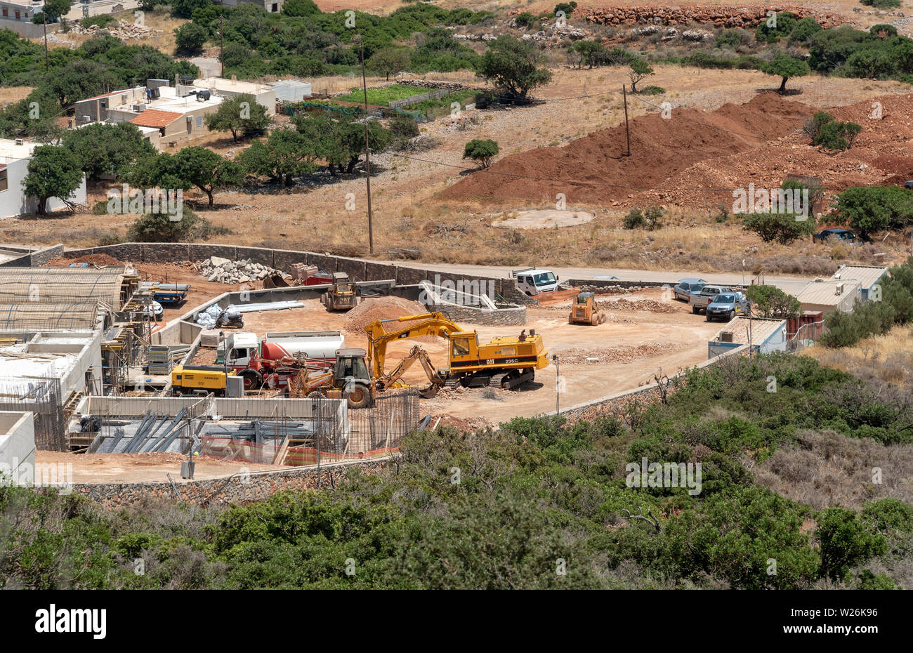 Plaka, Crete, Greece. June 2019. Construction work being carried out behind the coastal village of Plaka. Building new homes and apartments. Stock Photo