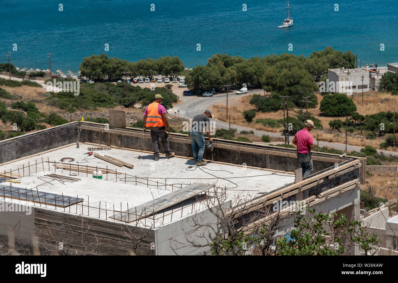 Plaka, Crete, Greece. June 2019. Construction work being carried out behind the coastal village of Plaka. Building new homes and apartments. Stock Photo