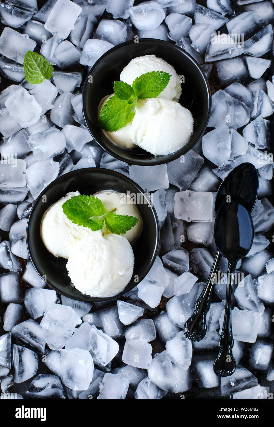 Vanilla ice cream in black bowl, top view Stock Photo - Alamy