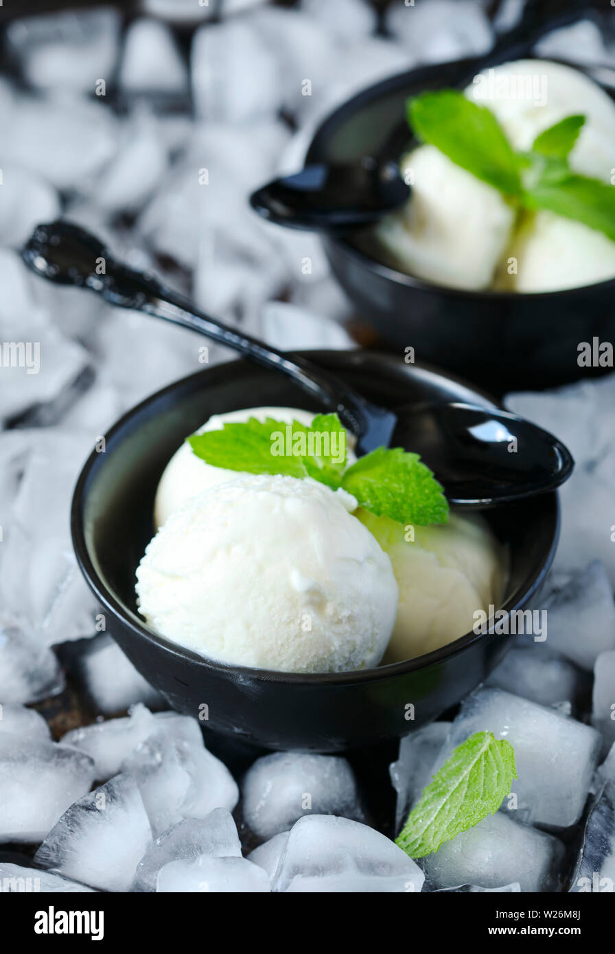 Vanilla ice cream in black bowl, top view Stock Photo - Alamy