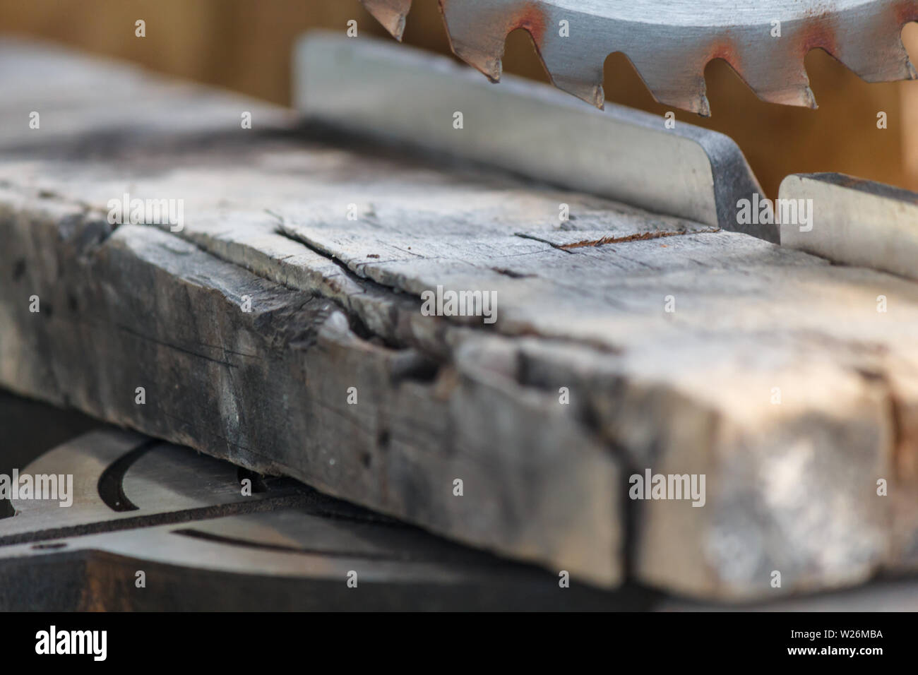 Old timber strip with teeth circular saw in workshop Stock Photo