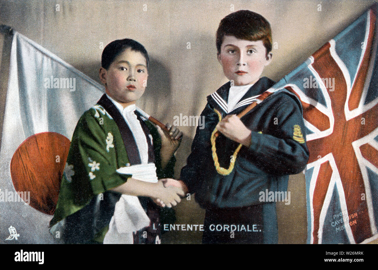 [ 1900s Japan - Anglo-Japanese Alliance ] —   This postcard, ca 1902, of a Japanese boy with the Japanese flag and a western boy with the British flag celebrates the Anglo-Japanese Alliance. The alliance was first signed on January 30, 1902 (Meiji 35) and extended in 1905 (Meiji 38)  and 1911 (Meiji 44) before expiring in 1921 (Taisho 10).  20th century vintage postcard. Stock Photo