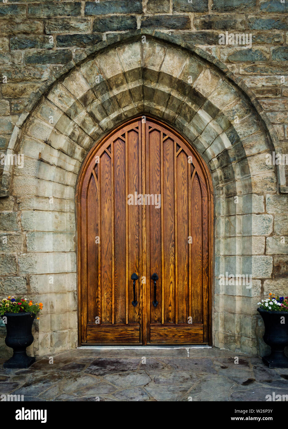 A large wooden oak arched doorway on St. Peter's Roman Catholic Church, Brownsville